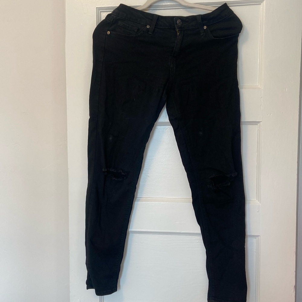 JUSTBLACK black skinny jeans with knee rips.